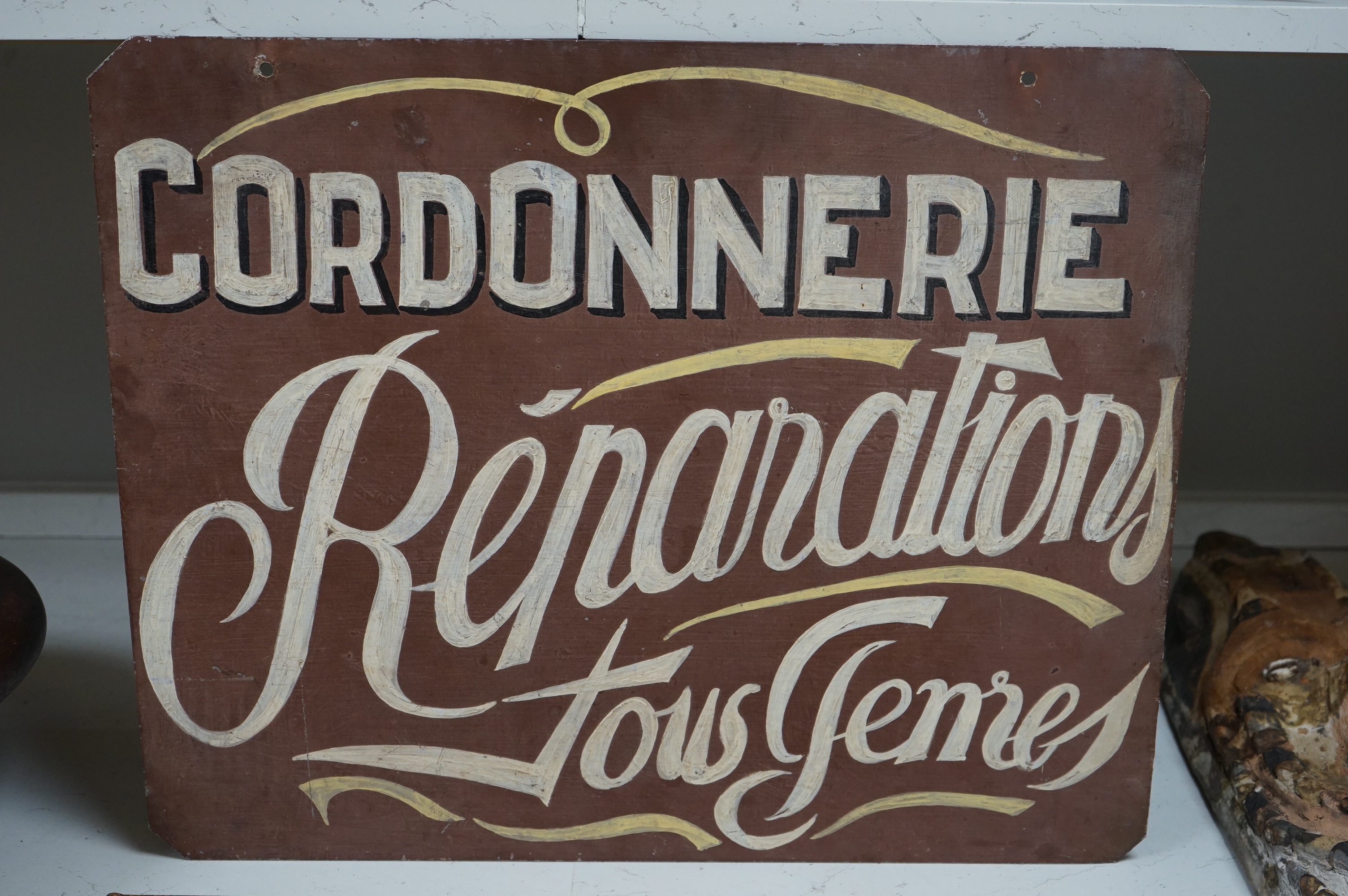 A painted French metal advertising sign ‘Cordonnerie’. 56.5cm wide x 45.5cm high. Condition - good